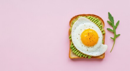 Delicious avocado toast with sunny side up egg against light pink background offering copy space