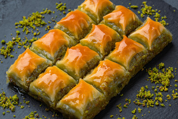 Turkish dessert pistachio baklava on black background. Special mini baklava