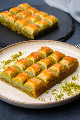 Turkish dessert pistachio baklava on black background. Special mini baklava