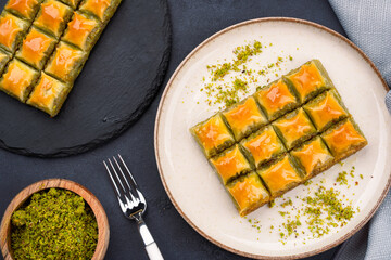 Turkish dessert pistachio baklava on black background. Special mini baklava