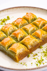 Turkish dessert pistachio baklava on white background. Special mini baklava