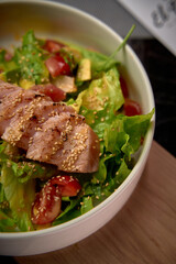 A Fresh and Colorful Salad Bowl Topped with Grilled Tuna and Garnished with Sesame Seeds for a Healthy Meal Option