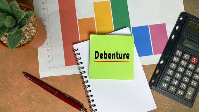 DEBENTURE symbol. DEBENTURE written on a sticky note. beautiful work desk.