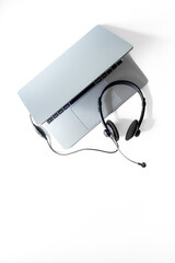 Headset and laptop top view. Customer support equipment at call center. Online conference. Online education concept