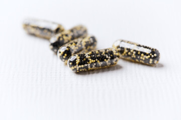 Iron capsules on bright background. Soft focus. Close up. Copy space.	