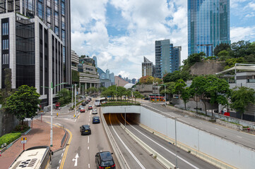 Fototapeta premium View of Salisbury road near Ave of Stars promenade, Kowloon. Cityscape, skyscrapers, traffic and people. Hong Kong, China. 20 May 2025