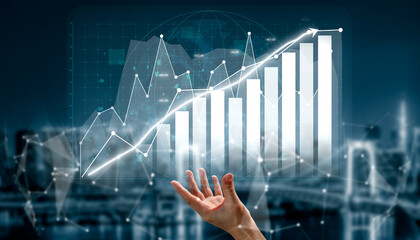 A hand reaches towards a digital bar graph, illustrating data growth and financial trends against a high-tech background, symbolizing innovation and progress. Impute