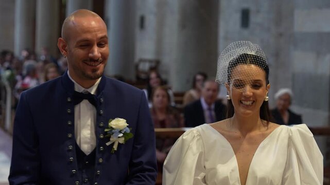 Young bride and groom standing together inside a beautiful church during their wedding ceremony