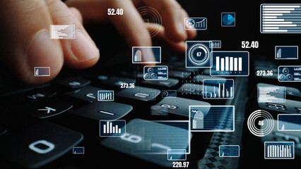 A close-up scene featuring hands typing on a keyboard, surrounded by floating digital graphs and data elements, illustrating the intersection of technology and data analysis in daily work. Xenic