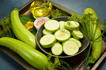 A bowl of sliced zucchini ready for cooking. Close-up. Top view.