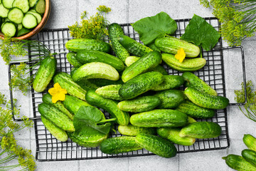 Fresh cucumbers ready for use. On a light kitchen table. Free space for text. Top view.