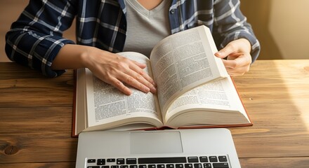 Naklejka premium Studying with textbook and laptop concept for education research and academic success