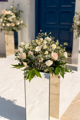 Stunning floral arrangements adorn a coastal venue for a romantic wedding celebration in Greece