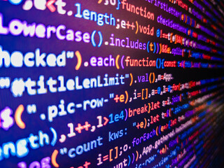 The word 'HACKED' mixed in a random minified javascript code with syntax highlighting. Programming code on computer monit. Creative Js HTML. Programming code typing