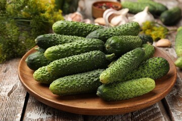 Making pickles. Fresh cucumbers and spices on wooden table, closeup