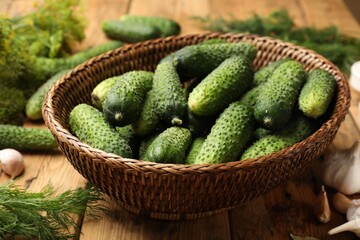 Making pickles. Fresh cucumbers and other ingredients on wooden table, closeup