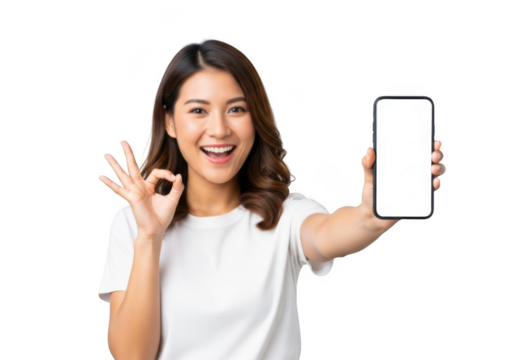 Happy young asian woman holding a blank smartphone and showing ok gesture, isolated on transparent background