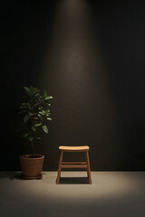 Simple wooden stool and green plant in a pot against a dark textured wall potted plant