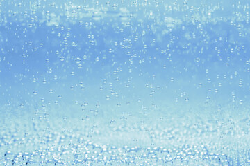 Soda water with bubbles of gas in glass, closeup