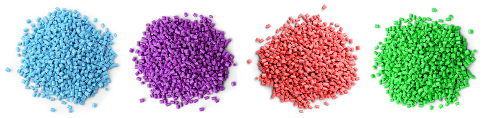 Plastic granules in different colors, top view. Piles on white background, set