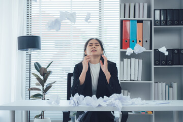 Business woman overwhelmed: A woman in a professional setting experiences intense stress,...