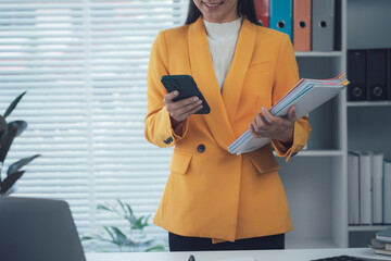 Focused Professional: A sophisticated individual, clad in a vibrant yellow blazer, is engrossed in...