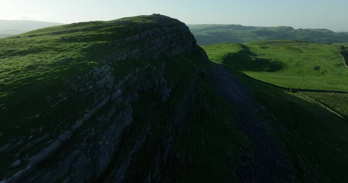 Rocky ridge and green pastures in Yorkshire Dales, England