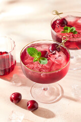Two glasses of cherry mocktail lemonade with ice