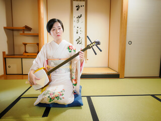 着物で三味線を演奏する女性