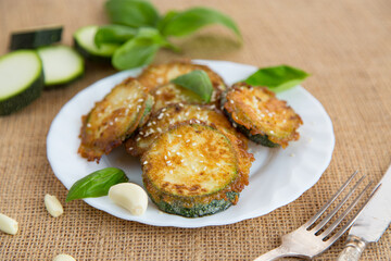 Golden zucchini slices in a crispy homemade breading on a rustic table