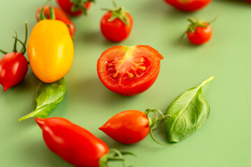 Ripe red and yellow tomatoes with fresh basil
