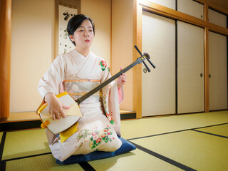 着物で三味線を演奏する女性