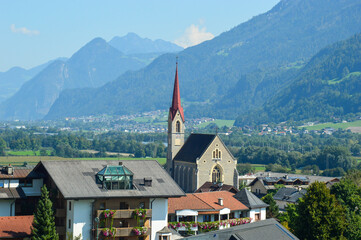 Fototapeta premium European town with church and mountains in background
