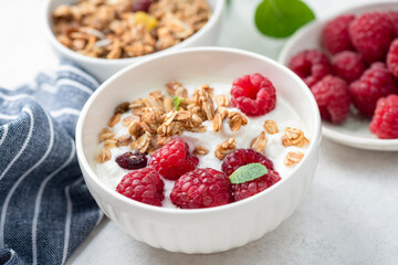 Muesli with berries and yogurt ib white bpwl closeup view, healthy food