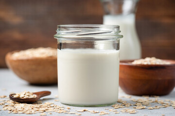 Vegetarian dairy free Oat Milk in glass jar, healthy alternative lifestyle