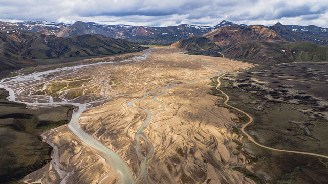 Aerial View of Braided River and Multicolored Mountains in Iceland