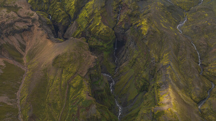 Aerial View of a Moss Covered Canyon with Waterfall in Iceland