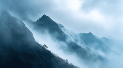 Fototapeta premium Majestic mountain peaks shrouded in ethereal mist. Atmospheric landscape evoking mystery, serenity, and adventure. Ideal for travel, nature, or inspirational themes.