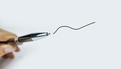 Pen in hand with a drawn line