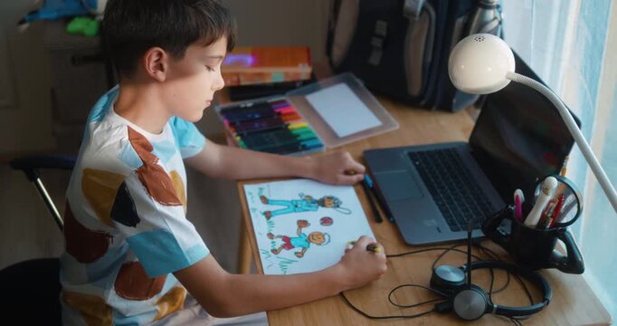 Young boy drawing a picture of himself and his father playing baseball. Drawing symbolizes his longing for a connection with his busy, often-absent dad.  Part 1 of the &ldquo;Dad&rsquo;s Day&rdquo; series.