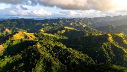 Fototapeta premium Aerial View of Green Mountain Ridges Under Cloudy Sky