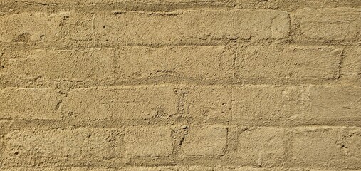 Beige painted brick wall with rough textured surface. Minimalist background for design, construction, and architectural details