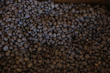 Brown Roasted Coffee Beans Closeup On Dark Background. High quality photo