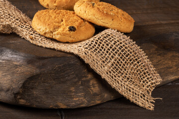 Homemade raisin cookies on a wooden country table with a cozy vibe