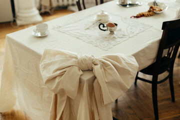 Decor tied tablecloth in the shape of a bow tie on a table in the kitchen living room.