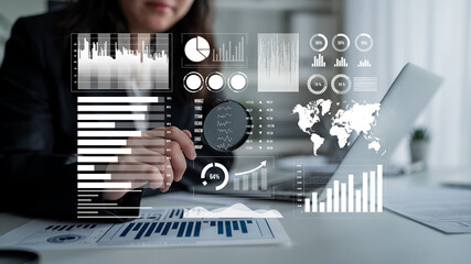 A business professional examines financial data on a digital interface, featuring various graphs and statistics to strategize and improve market performance. Impute