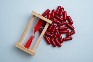 Time to take pills. Alarm clock shows time to take medicine. Taking vitamins or medicine. Concept of health care, medicine, pharmacy, disease prevention