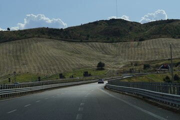 Mountain highway in southern Italy, seen from the driver's seat - a picturesque road through tunnels and hills, perfect for travel and adventure.