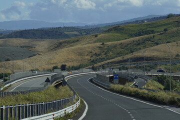 Mountain highway in southern Italy, seen from the driver's seat - a picturesque road through tunnels and hills, perfect for travel and adventure.