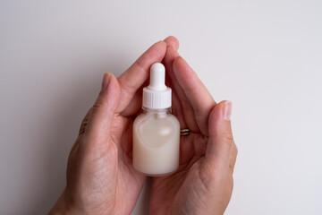 A jar of spa cream in the hands of a girl. Skin care. Medical and dermatological cosmetics for hands. Beauty and health of a woman. Spa treatments for the body. Container with natural cream close-up